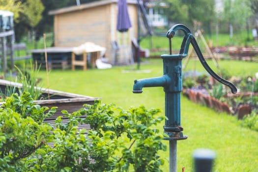Close up of well for watering urban gardening vegetable patches.