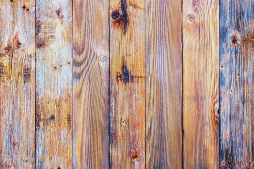 Texture of the planks of an old wooden table in antiqued pastel colors. Vintage rustic wooden background. Carpentry.