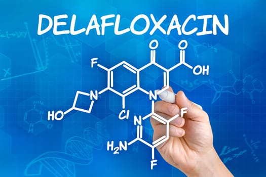Hand with pen drawing the chemical formula of Delafloxacin