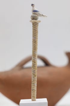 Huelva, Spain - Dec 20th, 2017: Dove-shape perfume stick stirrer. Glass paste. 2nd Century AC. Hueva Archaeological Museum