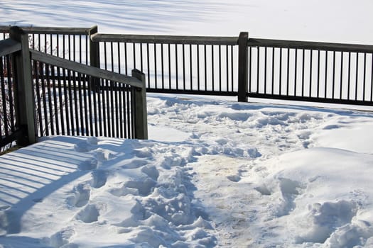 View of railing along a winter path.