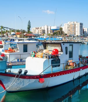 Marina with fishing boats, Larnaca skyline in background, Cyprus