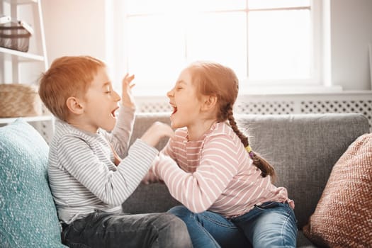 Two little kids having fight at home. Concept of the family relationship and friendship