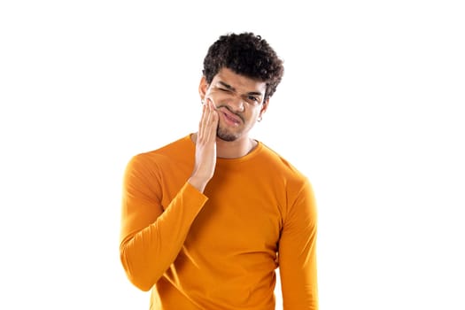 Cute african american man with afro hairstyle wearing a orange T-shirt isolated on a white background