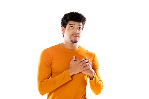 Cute african american man with afro hairstyle wearing a orange T-shirt isolated on a white background