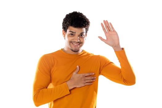 Handsome afro guy with his right hand on the heart isolated on a white background