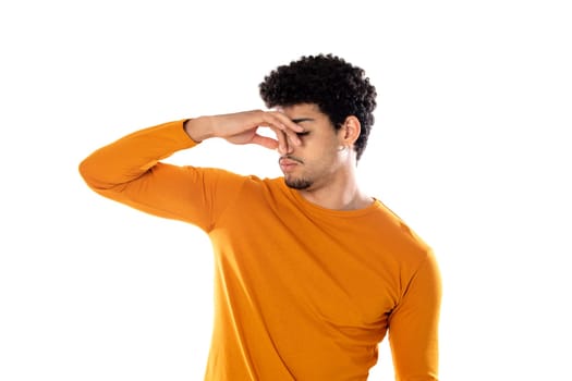 Cute african american man with afro hairstyle wearing a orange T-shirt isolated on a white background