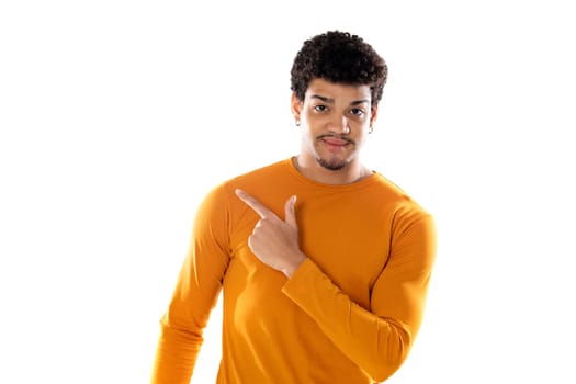 Young black afro guy laughing and pointing to something with his finger isolated on a white background
