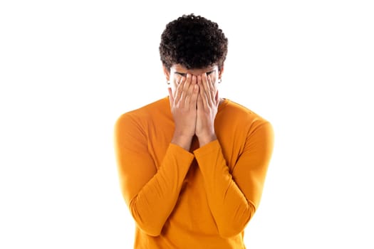 Cute african american man with afro hairstyle wearing a orange T-shirt isolated on a white background