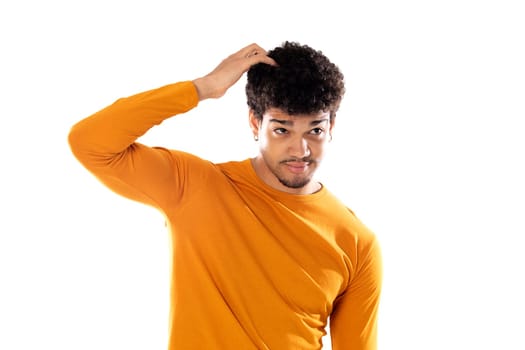 Cute african american man with afro hairstyle wearing a orange T-shirt isolated on a white background