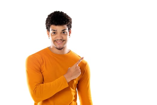 Young black afro guy laughing and pointing to something with his finger isolated on a white background