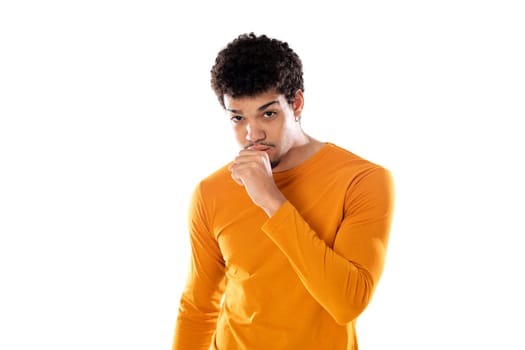 Cute african american man with afro hairstyle wearing a orange T-shirt isolated on a white background
