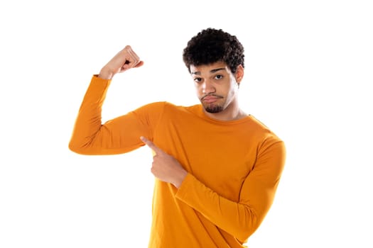 Young african american black man feeling happy, satisfied and powerful, flexing fit and muscular biceps, looking strong after the gym against isolated background