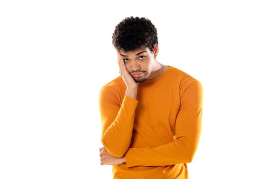 Cute african american man with afro hairstyle wearing a orange T-shirt isolated on a white background