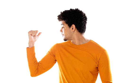 Young african american black man feeling happy, satisfied and powerful, flexing fit and muscular biceps, looking strong after the gym against isolated background
