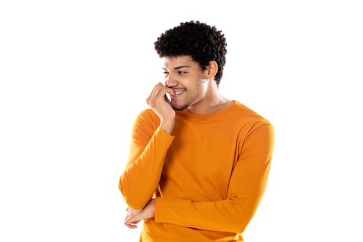 Cute african american man with afro hairstyle wearing a orange T-shirt isolated on a white background