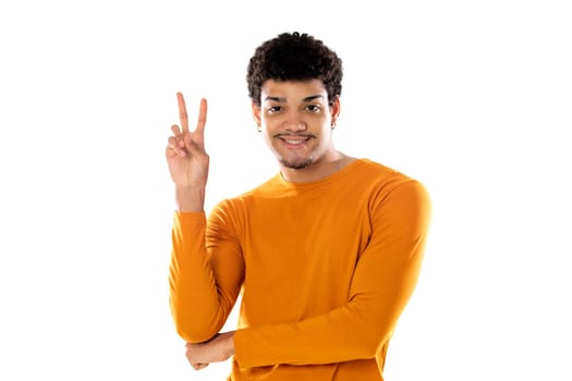 Cute african american man with afro hairstyle wearing a orange T-shirt isolated on a white background