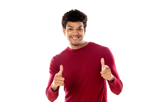 Cute african american man with afro hairstyle wearing a burgundy T-shirt isolated on a white background