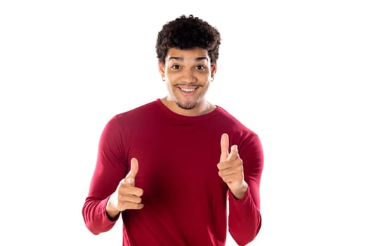 Cute african american man with afro hairstyle wearing a burgundy T-shirt isolated on a white background