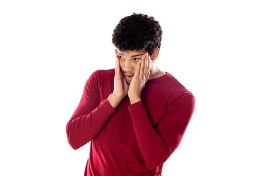 Cute african american man with afro hairstyle wearing a burgundy T-shirt isolated on a white background