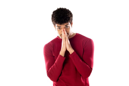 Cute african american man with afro hairstyle wearing a burgundy T-shirt isolated on a white background