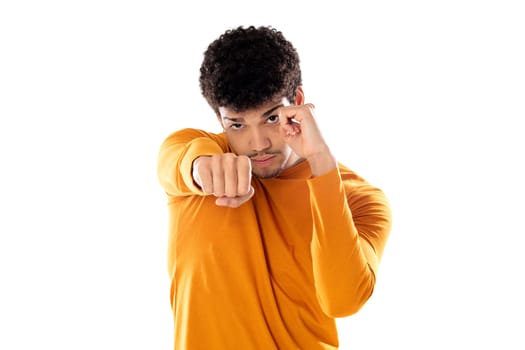 Cute african american man with afro hairstyle wearing a orange T-shirt isolated on a white background