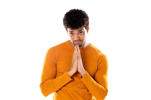 Cute african american man with afro hairstyle wearing a orange T-shirt isolated on a white background
