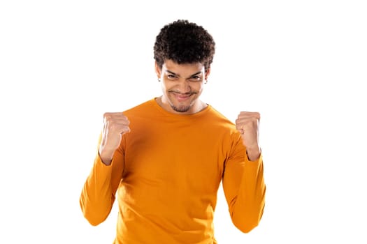 Cute african american man with afro hairstyle wearing a orange T-shirt isolated on a white background