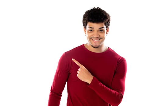 Cute african american man with afro hairstyle wearing a burgundy T-shirt isolated on a white background