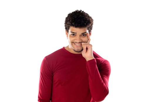 Cute african american man with afro hairstyle wearing a burgundy T-shirt isolated on a white background