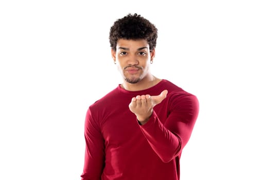 Cute african american man with afro hairstyle wearing a burgundy T-shirt isolated on a white background