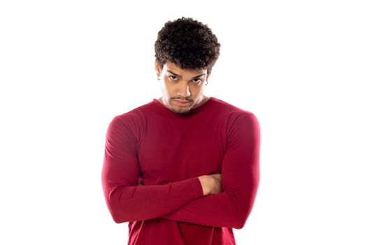 Cute african american man with afro hairstyle wearing a burgundy T-shirt isolated on a white background
