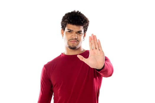 Cute african american man with afro hairstyle wearing a burgundy T-shirt isolated on a white background