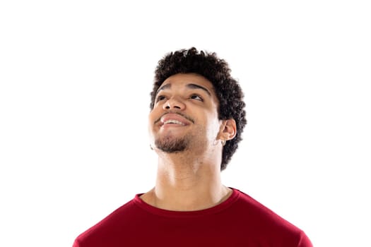 Cute african american man with afro hairstyle wearing a burgundy T-shirt isolated on a white background