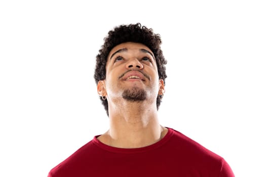 Cute african american man with afro hairstyle wearing a burgundy T-shirt isolated on a white background