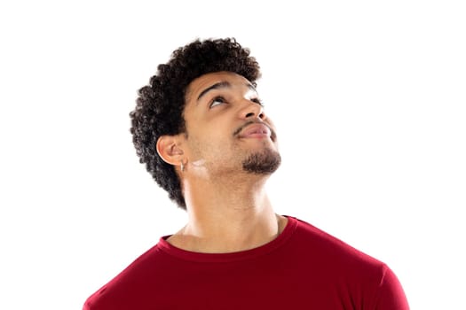 Cute african american man with afro hairstyle wearing a burgundy T-shirt isolated on a white background