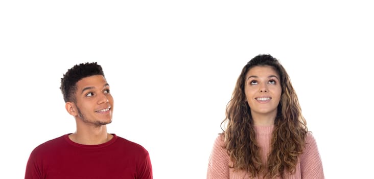 Attractive pensive happy young multiethnic couple isolated on a white background