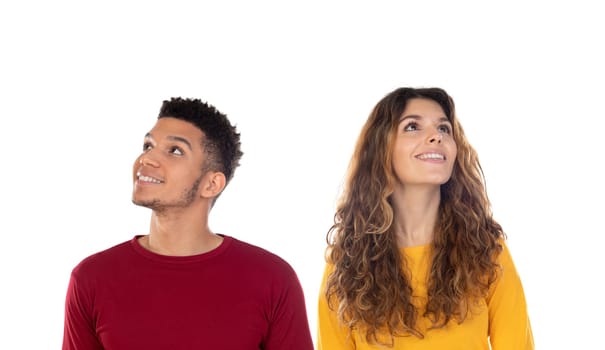 Attractive pensive happy young multiethnic couple isolated on a white background
