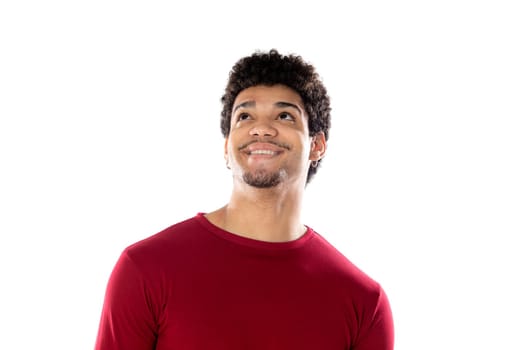 Cute african american man with afro hairstyle wearing a burgundy T-shirt isolated on a white background