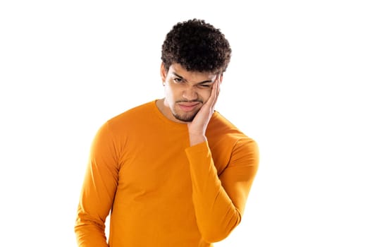 Cute african american man with afro hairstyle wearing a orange T-shirt isolated on a white background