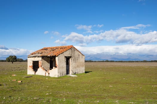 Abandoned and ruined house in the countryside. Stunning clouds in the sky