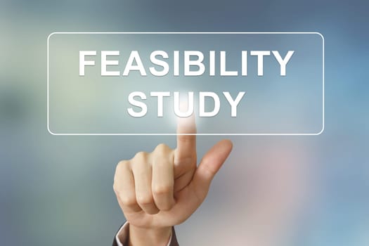 business hand pushing feasibility study button on blurred background