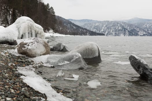 unfrozen Lake Teletskoye in winter. Russia Altai Krai.