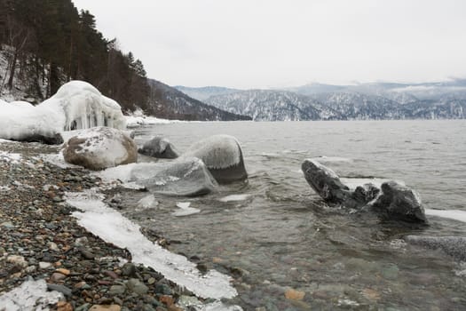 unfrozen Lake Teletskoye in winter. Russia Altai Krai.