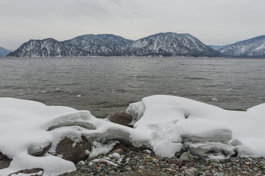 unfrozen Lake Teletskoye in winter. Russia Altai Krai.