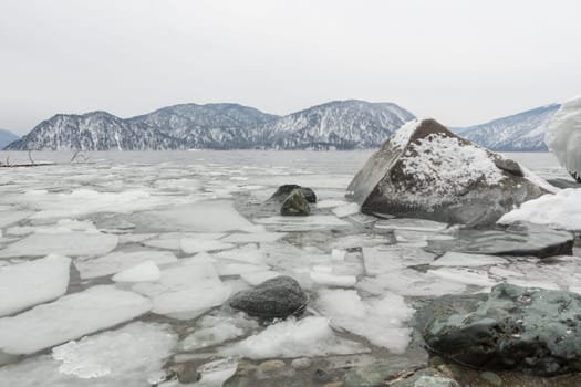 unfrozen Lake Teletskoye in winter. Russia Altai Krai.