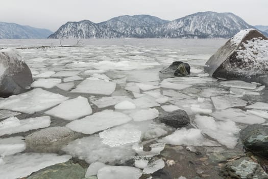 unfrozen Lake Teletskoye in winter. Russia Altai Krai.