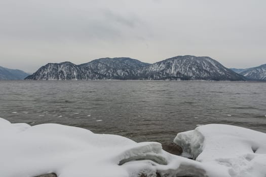 unfrozen Lake Teletskoye in winter. Russia Altai Krai.