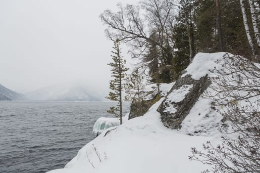 unfrozen Lake Teletskoye in winter. Russia Altai Krai.