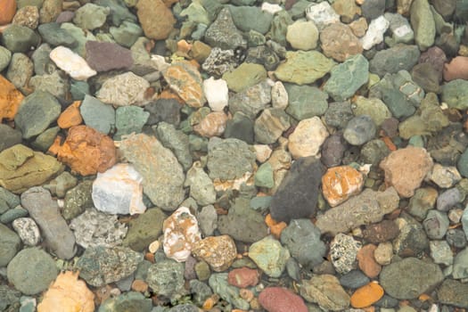 crystal clear water on Lake Teletskoye, through which you can see the stones lying on the bottom.Russia, Altai Krai.